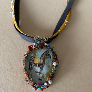 Necklace with glass pendent including the image of a Zebra