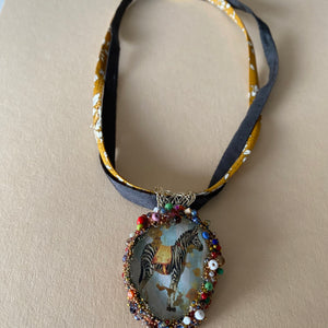 Necklace with glass pendent including the image of a Zebra